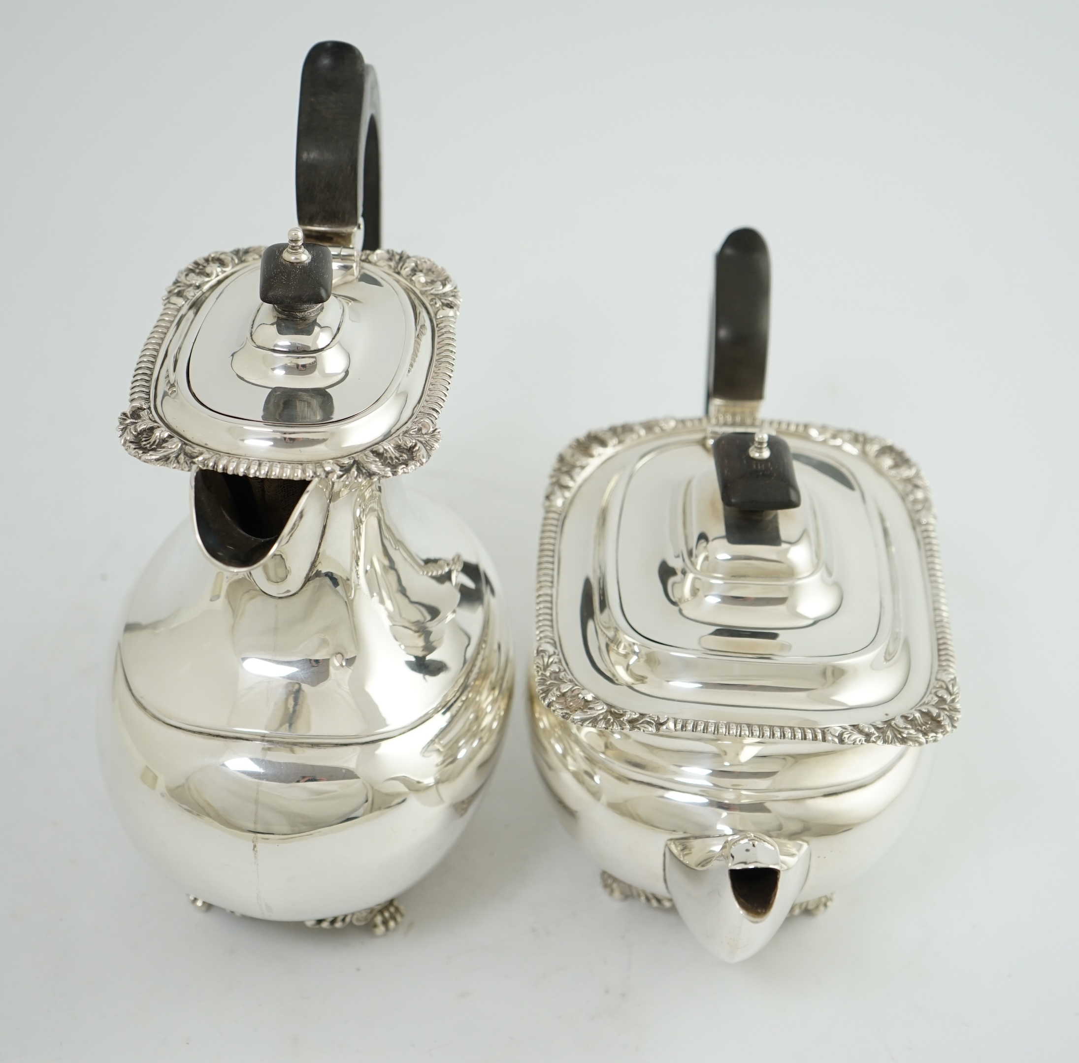 A George V silver hot water pot and matching teapot, by Reid & Sons